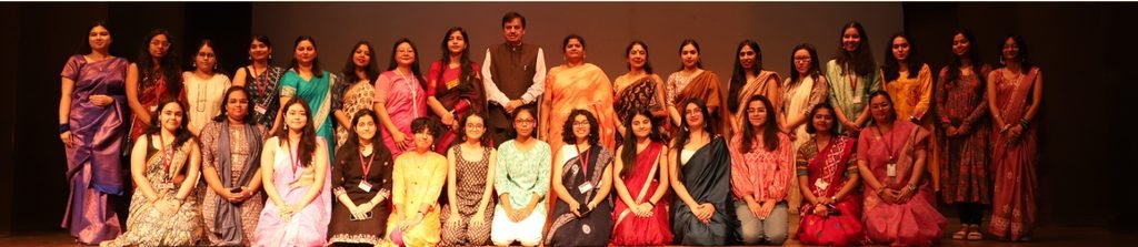 Ananya Mukesh kneeling as the fifth member from the left in a yellow dress along with her fellow team members of Book, Documentaries and Media in LSR, Delhi